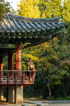 Woman standing in traditional pavilion in Jeonju