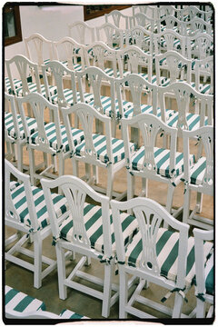 Multiple chairs placed in orderly rows