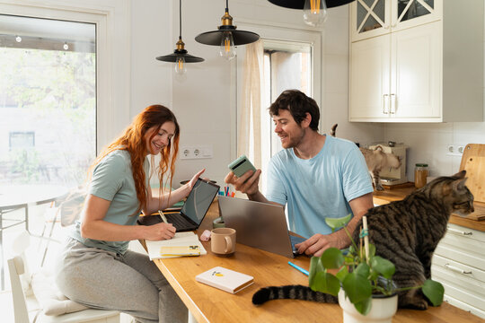 Couple Working Together in Kitchen  in the Morning 