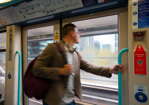 Man using smartphone while commuting in train