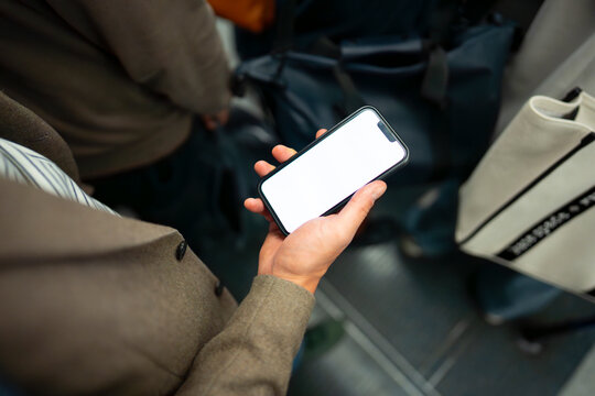 Using smartphone while sitting in tube