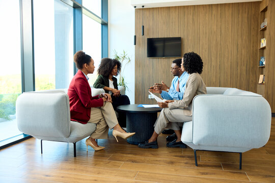 People discuss business topics in the lobby