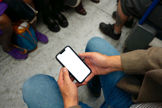 Close up of hands using smartphone in subway