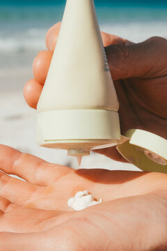 Squeezing Mineral Sunscreen Lotion into Hand