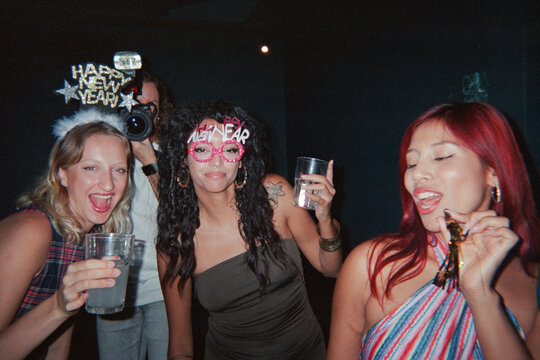 group of friends celebrating at new years party. Film. UGC