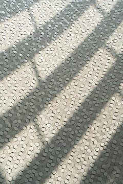 Dappled light on hexagon tile surface