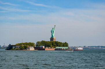 Statue of Liberty on Liberty Island with Ferry in New York Harbor © Martin