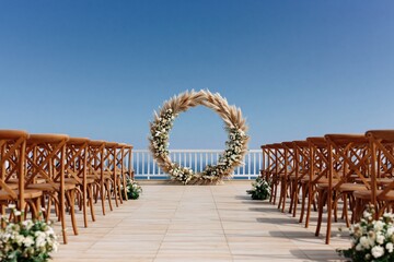 Naklejka premium Wedding ceremony arch floral outdoor terrace ocean seaside decor chairs