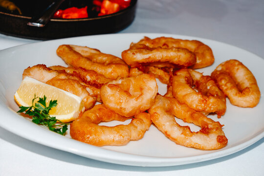 a plate of Spanish calamares a la romana on a restaurant table