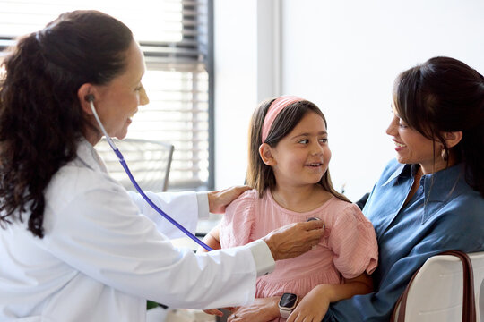 Doctor Examines Girl With Mom Present