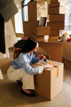 Woman Preparing Delivery Packages in Small Business Office