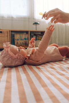 Baby reaching pacifier
