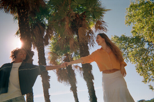 Two friend laughing in backlight over blue sky. UGC. Film
