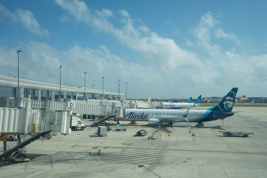 Kenner, LA, USA - Apr 5, 2025: Airliners operated by Alaska Airlines and United Airlines are seen parked at terminal gates in Louis Armstrong New Orleans International Airport (MSY).