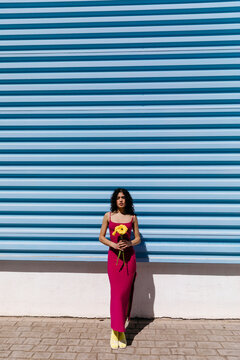 Woman against blue striped wall