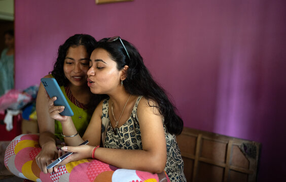 Young Woman browsing smartphone and enjoying inside home