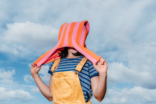 Person wearing a colorful bag over their head