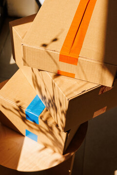 Delivery Stacked Cardboard Boxes with Blue Orange  Tape