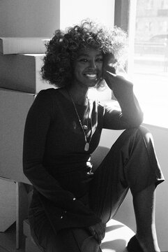 Woman smiling by window indoor portrait film photo