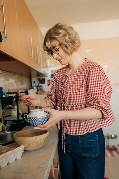 Woman preparing breakfast in home kitchen