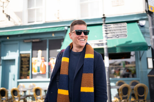 Smiling tourist exploring city during vacation