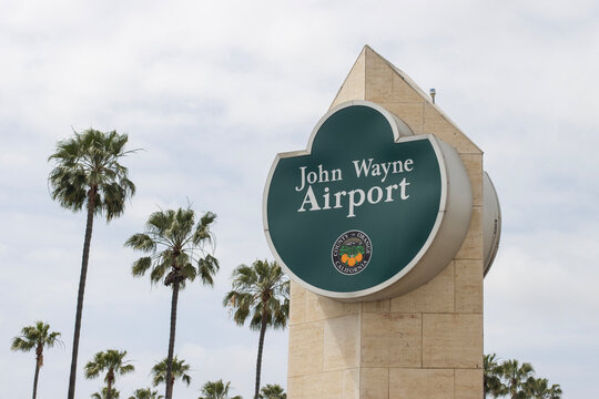 Santa Ana, CA, USA - May 8, 2022: The John Wayne Airport sign in front of the airport terminal building in Santa Ana, Orange County, California.