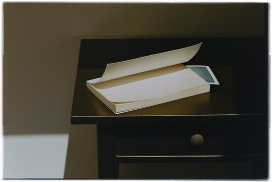 Book on Wooden Nightstand in Morning Light