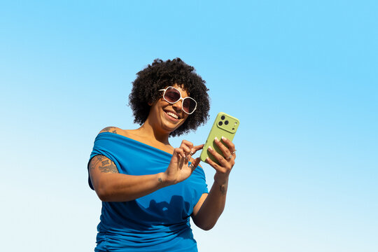 Pretty Black mobile phone outdoors blue sky