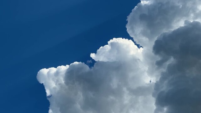 Dramatic Cumulus Cloud Formation: A striking image captures the majestic power of a towering cumulus cloud against a vibrant blue sky, hinting at atmospheric grandeur.