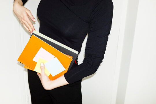 Person having office tools books and papers in business work office
