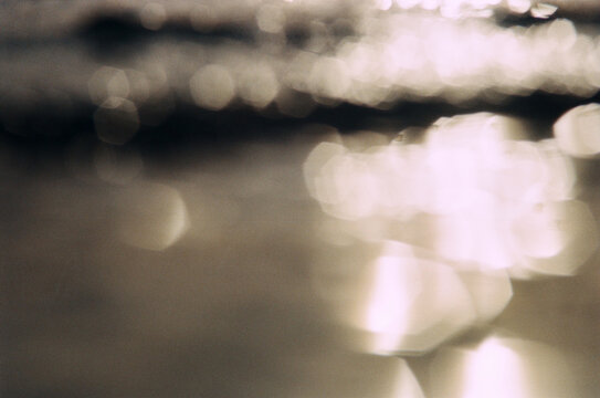 Reflections on water surface at beach in sunlight