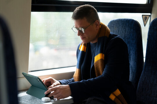 Man using tablet during train journey
