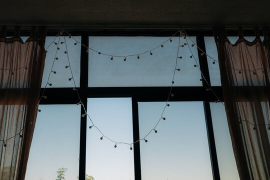 Decorative string lights hanging on window indoors