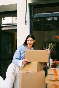 Portrait of Woman with Package Delivery Outside Shop on Film