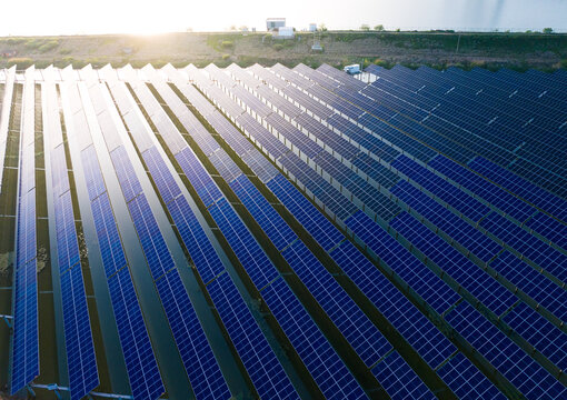 Aerial View of Large Solar Farm Beside Open Water