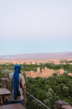 Man Overlooking Ancient Kasbah in Dades Valley, Morocco