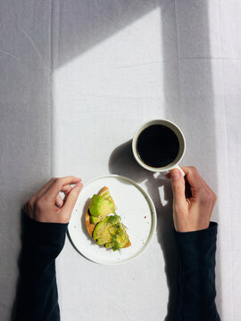POV avocado toast and coffee breakfast at home