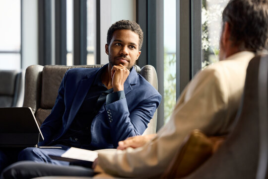 Businessman thoughtful while listening his teammate