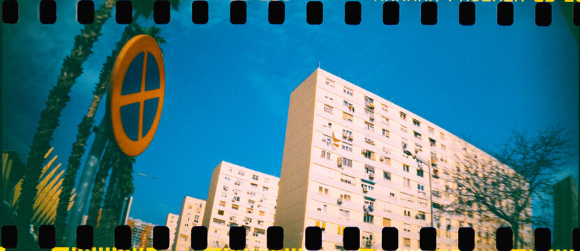 apartment buildings and a street sign in a city, 35mm film