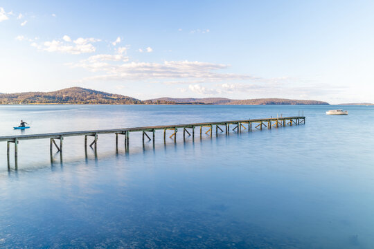 Old wooden jetty for small boats at lakes edge