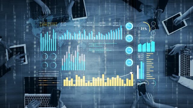 High-tech business analysis table showcasing data graphs, charts, and digital screens with multiple hands engaging with devices in a modern workspace. Entropy.