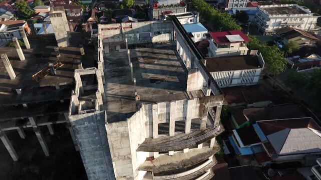 A view from atop an abandoned concrete building and an unfinished urban development project in an urban area of Pontianak, Indonesia.