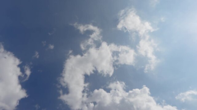 Passenger Airplane Flying Overhead Against Blue Sky and Clouds