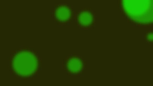Abstract green bokeh circles on dark background with soft light particles and blurry motion