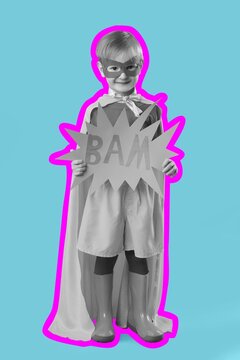 Young boy superhero costume holding bam sign, childhood imagination and play, creative kids concept, comic book style