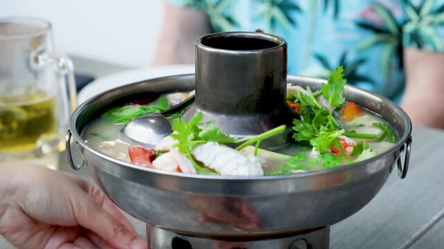 Traditional Thai Tom Yum Seafood Hot Pot Served in Metal Bowl