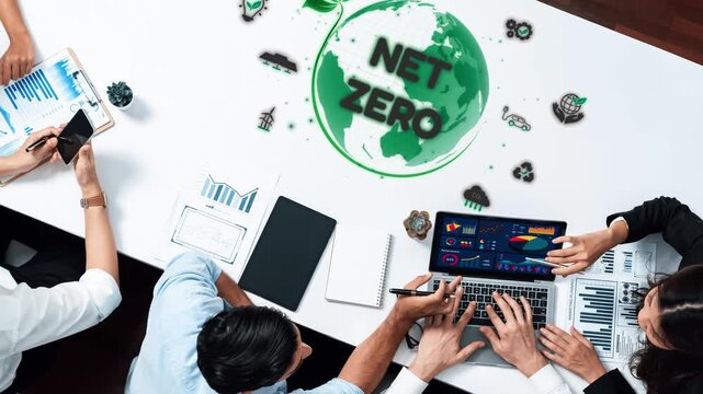 A collaborative business meeting focused on achieving net zero goals featuring graphs, charts, and sustainability strategies. Ideal for eco-friendly concepts. Raster