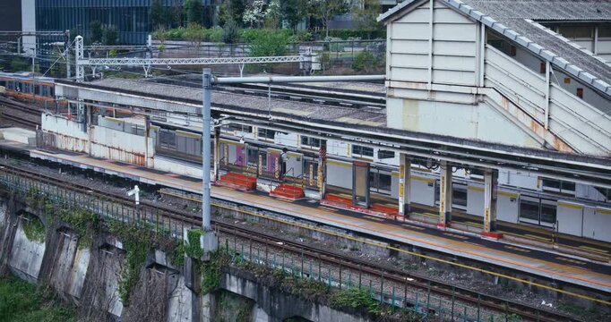 Orange Commuter Train Passing Station Platform, High Angle, Japan