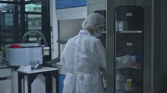 Professional Scientist Wear Cleanroom Suit Take Sample From Laboratory Dry Cabinet
