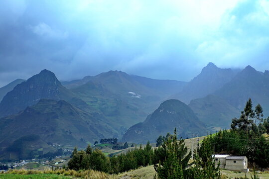 Mountains shrouded in mist, with farm fields in the foreground, outside of Latacunga, Ecuador